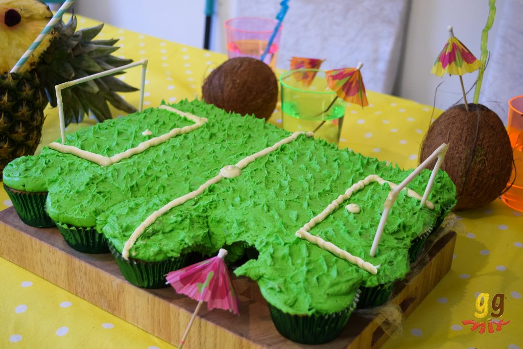 foot ball pitch made of cupcakes with green lime icing as the grass white buttercream for the pitch lines and goal posts made from cake pop sticks