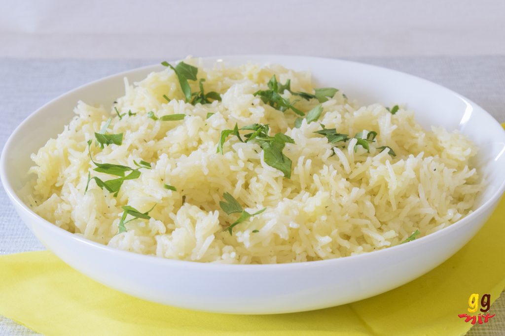 a bowl of lemon rice sprinkled with parsley 