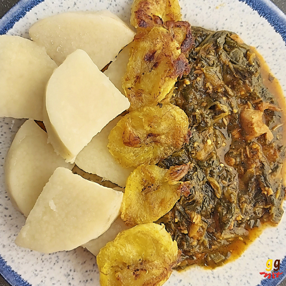 A PLATE OF PUNA YAM CHUNKS FRIED PLANTAIN AND KONTOMIRE GHANAIAN LAMB AND SPINACH STEW